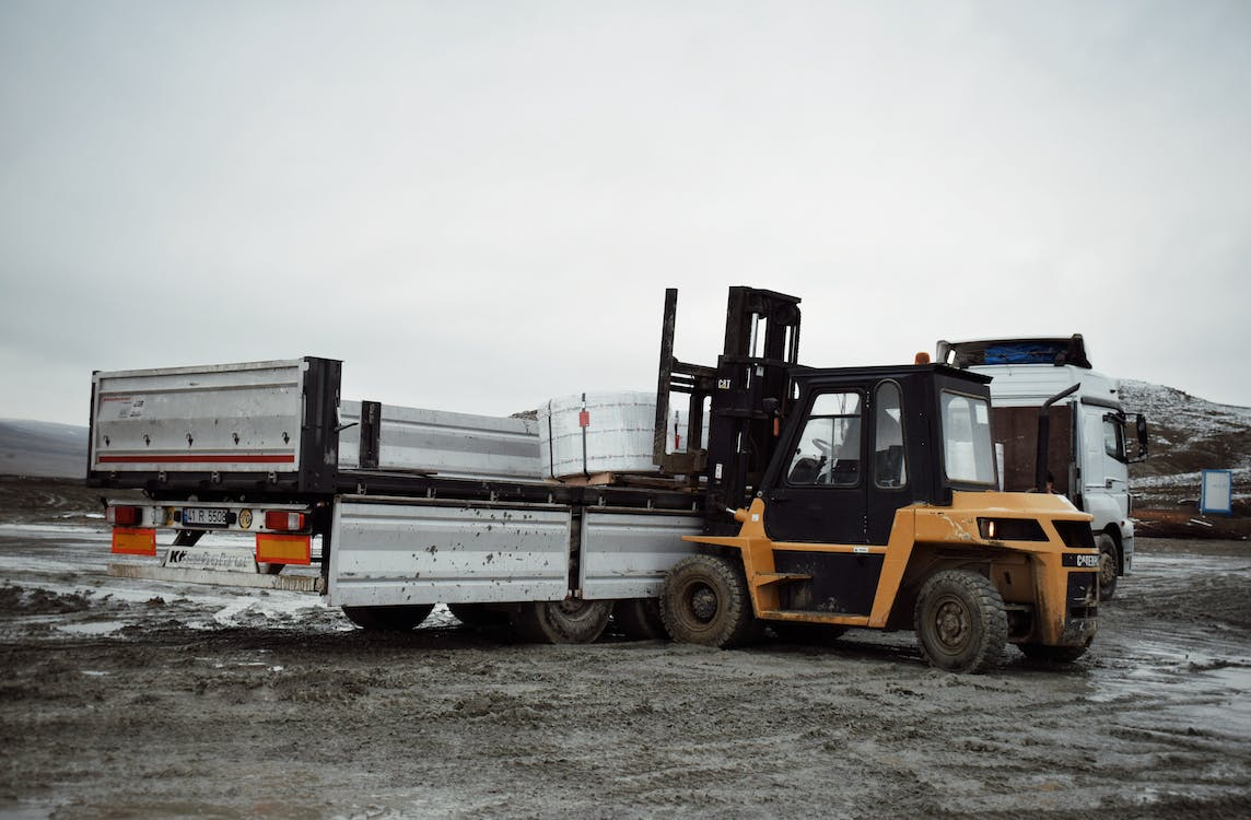 Forklift Loading Cargo On Truck