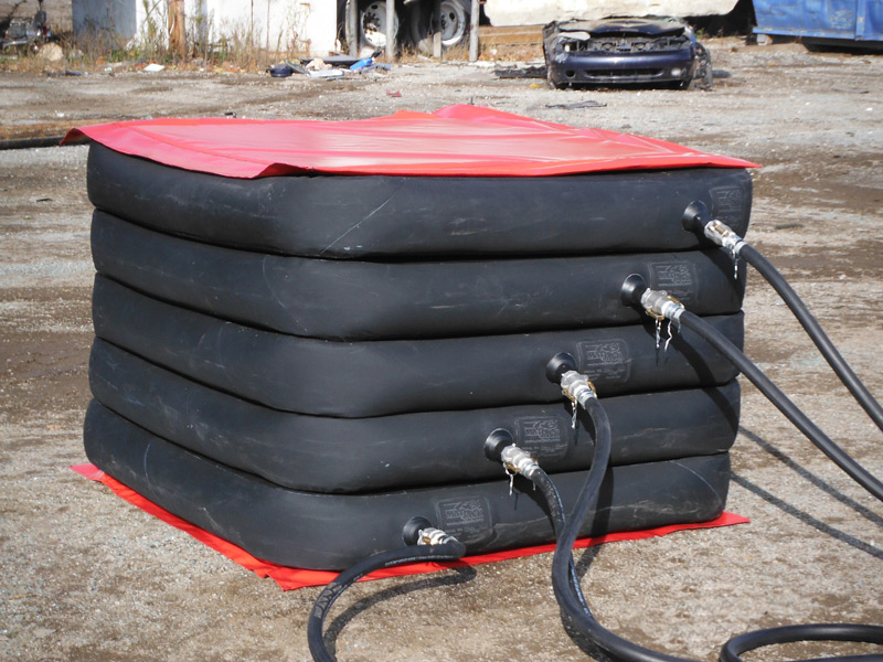 Air lifting bags in use at a construction site for moving heavy equipment.