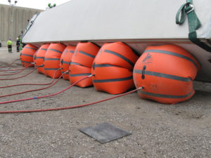 Large Safelift recovery cushions inflating beneath tipped trailer