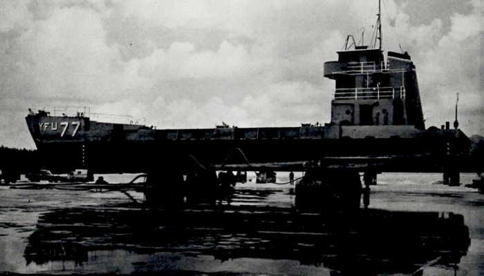 Air Caster Transporters being used to support and carry a navy ship across dry land.