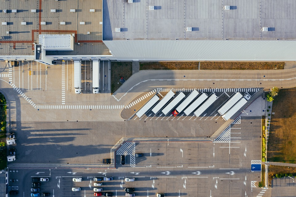 An aerial view of trucks parked outside a warehouse