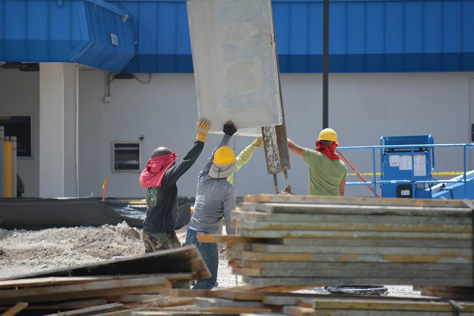 Workers handling loads manually in a facility