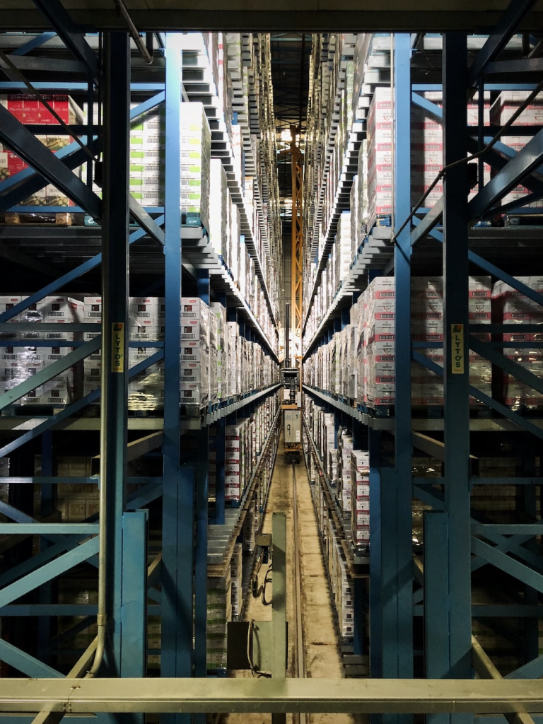 A View of the Minute Space Between Two Shelves of an Automated Warehouse Where Aisles Are Negligible
