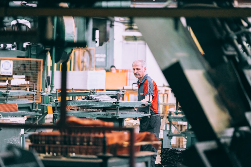 A warehouse staff member moving a heavy load