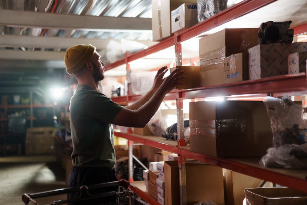 staff moving a box in the warehouse storage